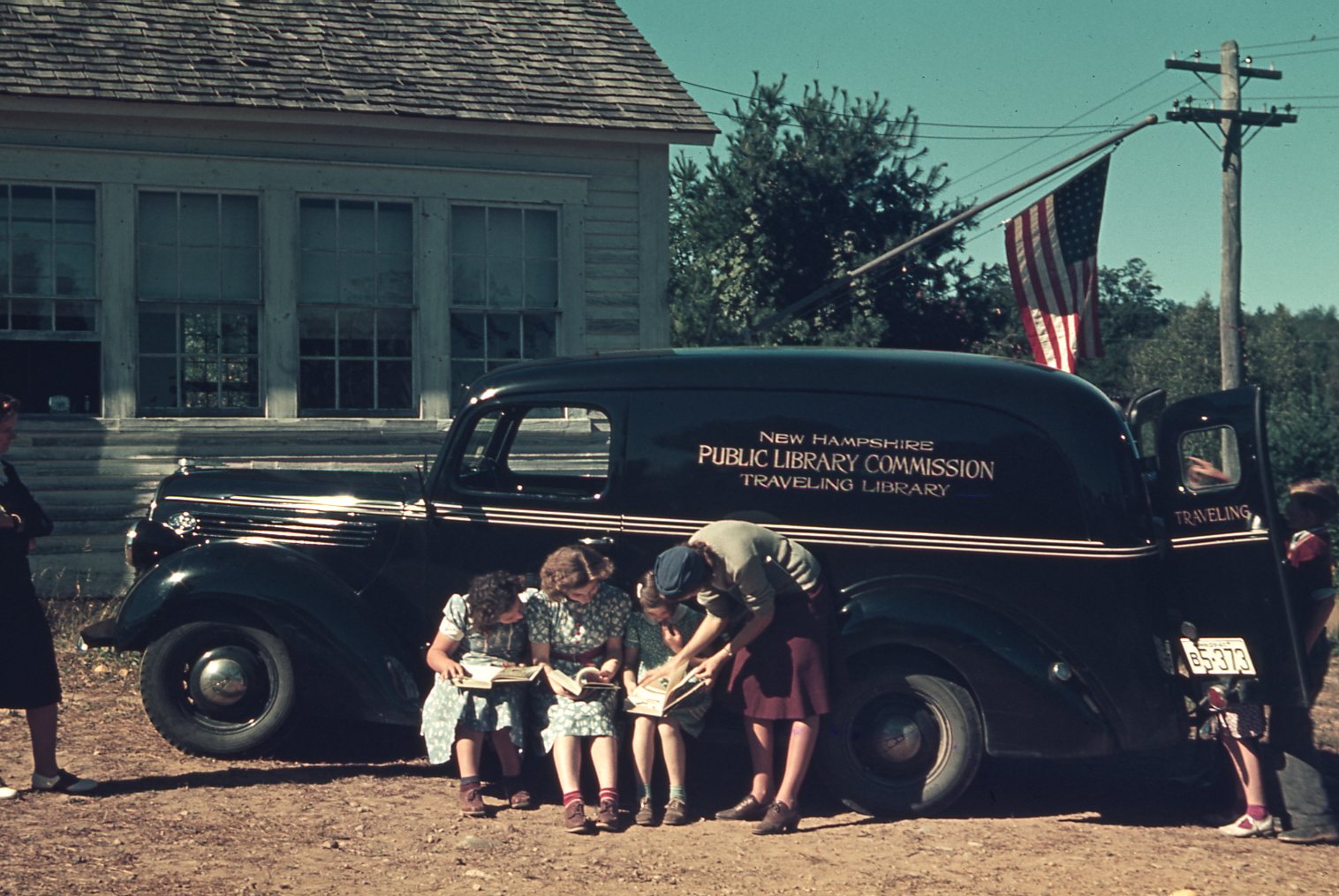 Children surround the bookmobile.